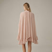 FJØRNA ruffle chiffon mini dress with high neck and layered fit, shown from the back in salmon color.