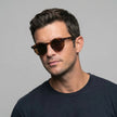 Men's FJØRNA polarized sunglasses with glare-reducing lenses, suitable for outdoor activities, shown on a model.