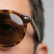 Men's FJØRNA polarized sunglasses with glare-reducing lenses for outdoor activities, featuring sleek black frames.