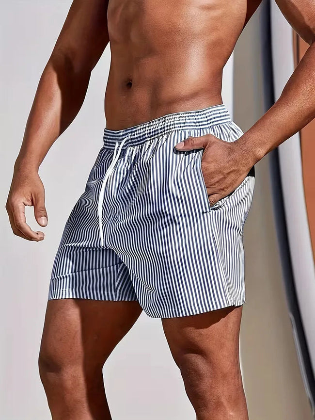Men's striped regular fit swim shorts by FJØRNA, featuring a colorful pattern and elastic waistband, perfect for summer beachwear.