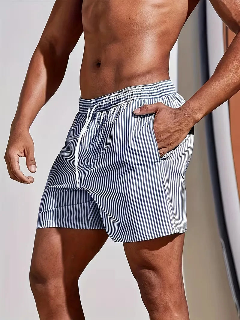 Men's striped regular fit swim shorts by FJØRNA, featuring a colorful pattern and elastic waistband, perfect for summer beachwear.
