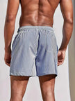 Men's striped regular fit swim shorts by FJØRNA, featuring a colorful pattern and comfortable fit for beach or pool.