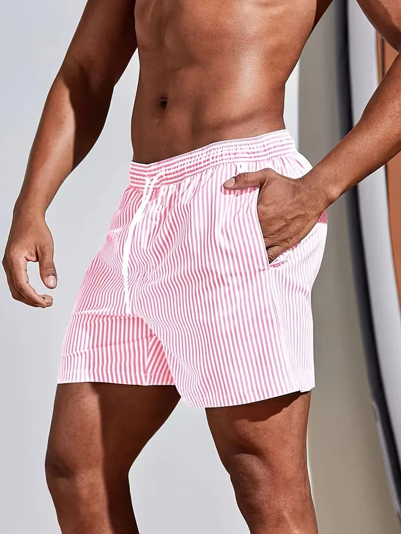 Men's striped FJØRNA swim shorts with a regular fit, featuring a vibrant summer design, perfect for beach and pool activities.