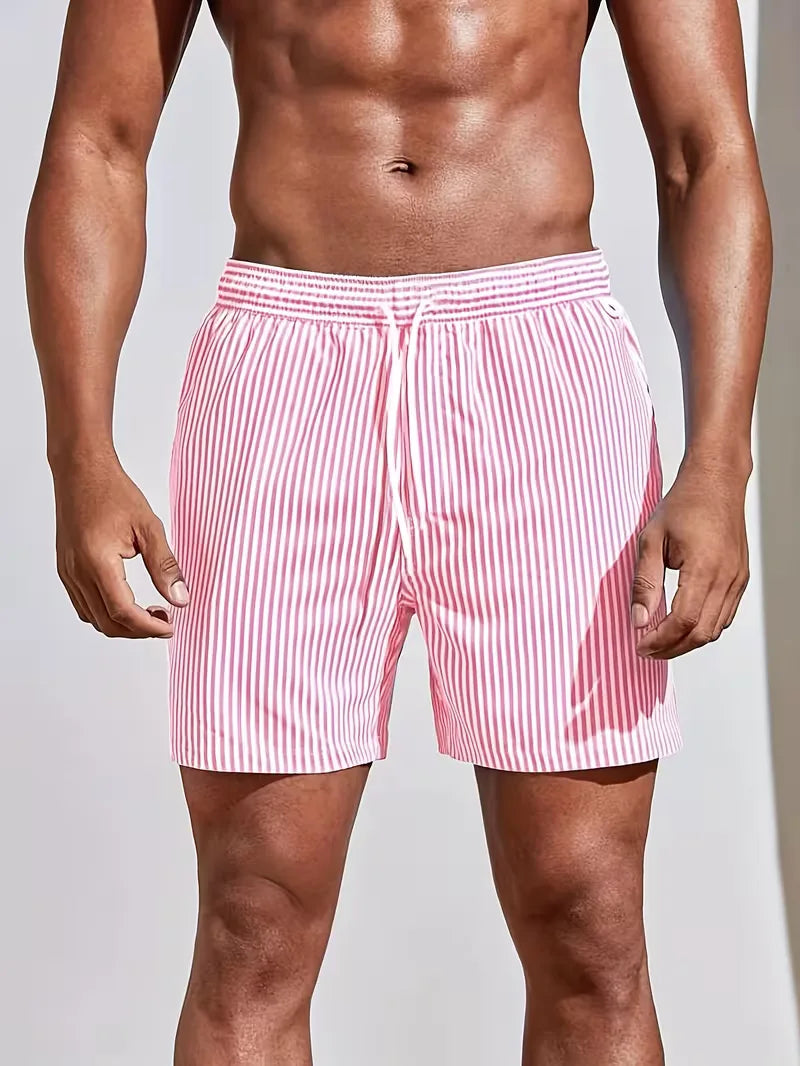 Men's striped FJØRNA swim shorts with a regular fit, featuring a colorful pattern, suitable for summer beach and pool wear.